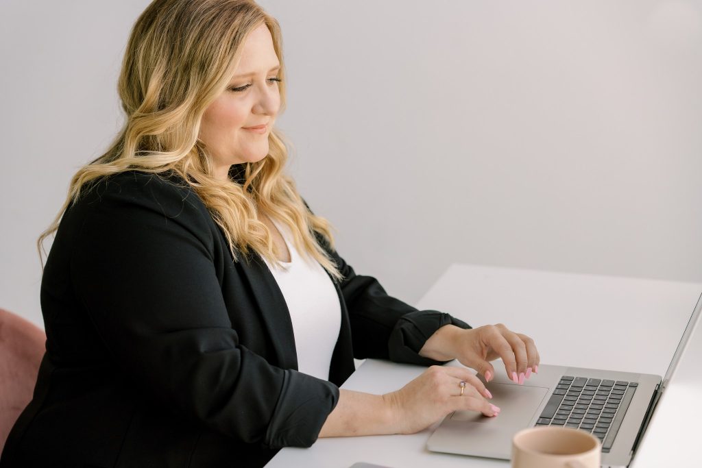 Professional Realtor sitting at desk and looking at computer